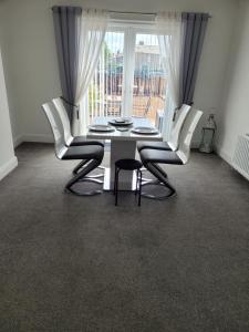 a table and chairs in a room with a window at Bracken Dene in Lynemouth