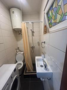 a bathroom with a sink and a toilet and a window at Apartman Savo in Kotor +20 photos