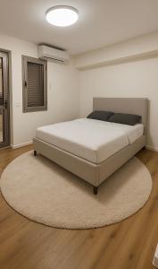 a large bed in a room with a rug at Sunny Coastal villa, luxury gateway! in Caesarea