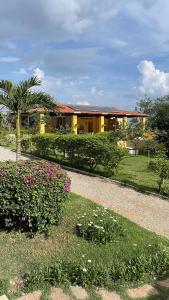 a building with a garden with flowers in front of it at flat 013 - Serra Negra - Bezerros - PE in Bezerros