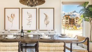 a dining room with a wooden table with chairs at Creekside Elegance at Timberstone in Canmore