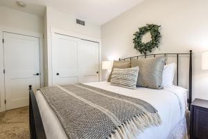 a bedroom with a bed and a wreath on the wall at Creekside Elegance at Timberstone in Canmore
