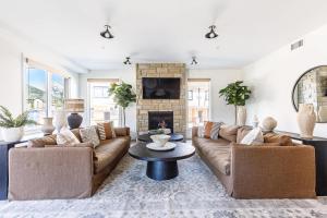 a living room with two couches and a fireplace at Creekside Elegance at Timberstone in Canmore