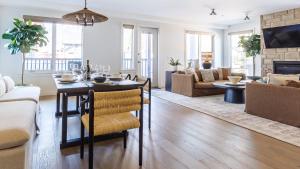 a living room with a table and a dining room at Creekside Elegance at Timberstone in Canmore +78 photos
