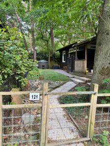 a fence with a sign on it in front of a yard at Infinity met hottub op Jocomo Park in Lanaken