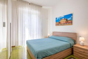 a bedroom with a bed and a large window at La Casa del Sole-Viareggio in Viareggio