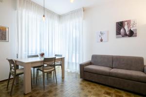 a living room with a table and a couch at La Casa del Sole-Viareggio in Viareggio