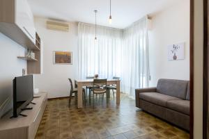a living room with a couch and a table at La Casa del Sole-Viareggio in Viareggio