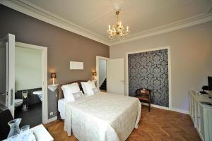 a bedroom with a bed and a chandelier at Guesthouse Expo 13 in Ghent