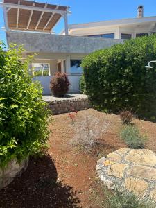 a house with bushes and a walkway in a yard at Star Holidays in Ceglie Messapica +11 photos