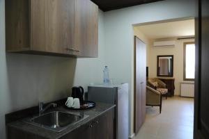 a kitchen with a sink and a refrigerator at LaForge Resort 