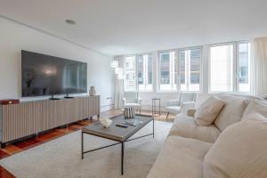 a living room with a couch and a table at Harrods Platinum Pad in London