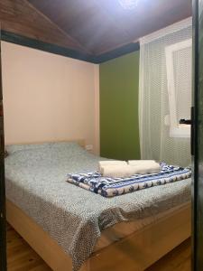 a bed with two towels on it in a room at Drinski kucerak in Okletac