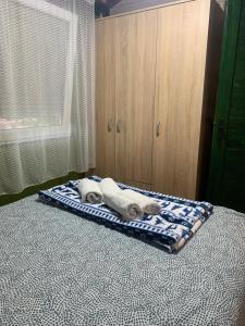 a bed with two towels on top of it at Drinski kucerak in Okletac +29 photos