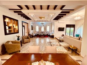 a large living room with couches and a couch at Maison d'Hôte Angele in Sfiani