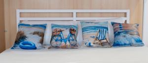 a group of pillows on a bed with a bike at Il Faro in Chioggia