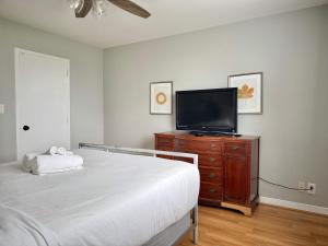 Un dormitorio con una cama y un televisor sobre una cómoda. en Downtown Stunning City View Onsite PARKING LM1102, en Atlanta