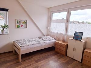 a small bedroom with a bed and a window at Marlerei in Marl