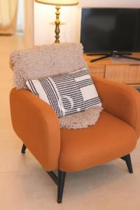an orange chair with a blanket on top of it at GC - La Voile in Wissant