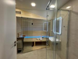 a bathroom with a glass shower and a sink at STUDIO KRÁLOVICE Apartment in Prague