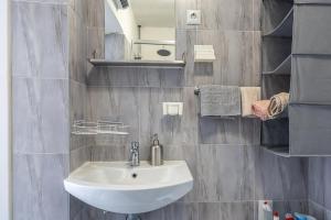 a bathroom with a sink and a mirror at Dvokrevetna soba Lela in Crikvenica +18 photos