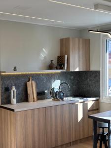 a kitchen with wooden cabinets and a sink at Caruso Central Apartments in Lefkada