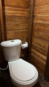 a bathroom with a toilet and a roll of toilet paper at Renacer in Termales - agua caliente - nuqui