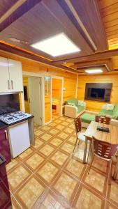 a large living room with a table and a kitchen at Çakıroğlu Villa Kent in Uzungol