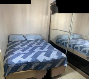 Un dormitorio con dos camas con sábanas azules y blancas. en Apartamento para Cop30, en Ananindeua