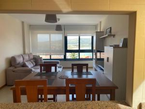 a kitchen and living room with a table and chairs at ENV Langosteira in Fisterra
