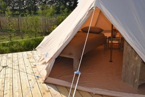 a tent with a bed inside of it at Tente Zéla in Ambillou-Château