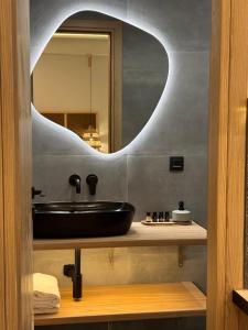 a bathroom with a sink and a mirror at Caruso Central Apartments in Lefkada +11 photos
