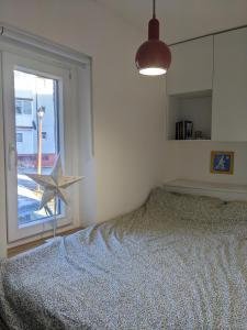 a bedroom with a bed and a large window at Hikers' Corner - Planinarka in Kolašin