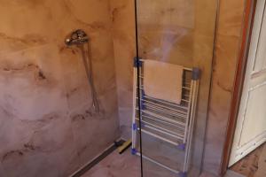 a bathroom with a shower with a towel at Przy jeziorze in Kaliska Kośierskie