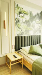 a bedroom with a bed with a table next to it at Apartament MARIA in Biała Podlaska +17 photos