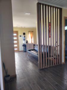 a room with a gate with a couch in it at Cabaña entre Bosques in Concepción