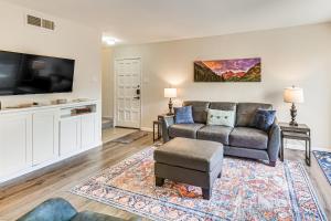 a living room with a couch and a tv at WFH-Friendly Condo Near Galleria in North Dallas! in Dallas
