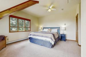 a bedroom with a bed and a ceiling fan at Lakeview Home with new hot tub - Sleeps 10 in Sandpoint
