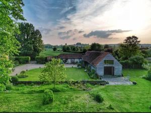 an aerial view of an old barn in a field at Haybarn Cottage in Alton