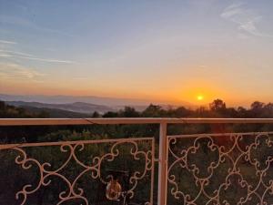 a view of the sunset from a balcony at Vikendica Dania in Tuzla +4 photos