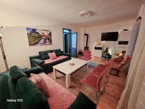 a living room with a couch and a table at Vikendica Dania in Tuzla