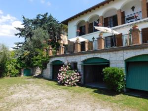 a building with garages and balconies on it at Villa Maria Lake View,7 minuti a piedi dal centro, parcheggio privato in Torri del Benaco
