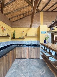 a kitchen with wooden cabinets and a sink at Casa La Iguana, Villa de Leyva - 8 minutos al pueblo in Villa de Leyva