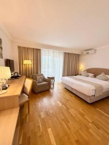 a hotel room with a large bed and a chair at Krystal Boutique Mansion in Hunedoara +215 photos