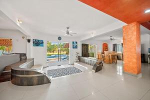 a living room with a couch and a table at Tranquilo - Private Pool Near Beach Sleeps 16 in Ixtapa