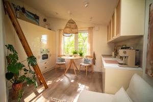 a small kitchen with a table and a kitchenette with a sink at Lazurowe Poddasze in Sanok +8 photos