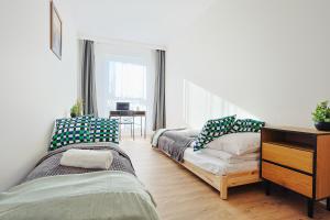 Ένα ή περισσότερα κρεβάτια σε δωμάτιο στο Meet and Greet, apartament przy hali koncertowej