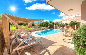 a patio with a hammock and a swimming pool at Allas Villa Heated Pool in Chania