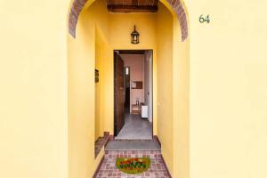 a hallway of a house with yellow walls at B&B Bianchi 64 in Pisa