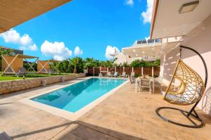 a villa with a swimming pool and a patio at Allas Villa Heated Pool in Chania